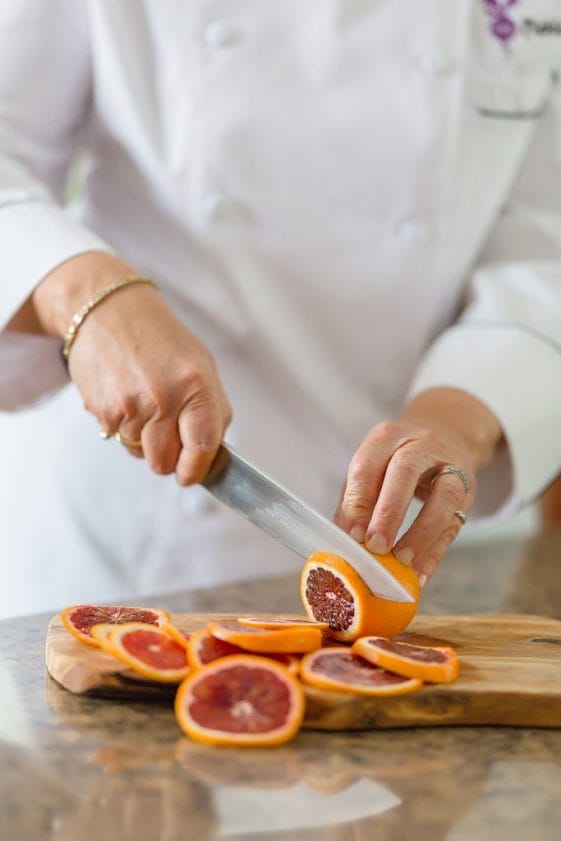 Miami’s Chef Liz slices blood oranges.
