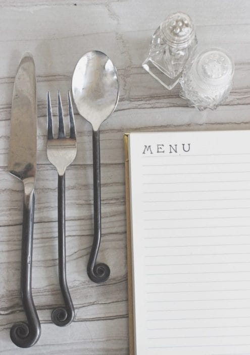 Meal planning notebook sits on a table. 