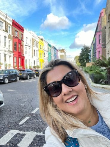 Chef Julia poses in front of street full of colorful buildings