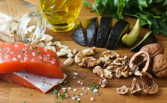 An anti-inflammatory diet containing fatty fish, avocado, walnuts, and healthy oils.